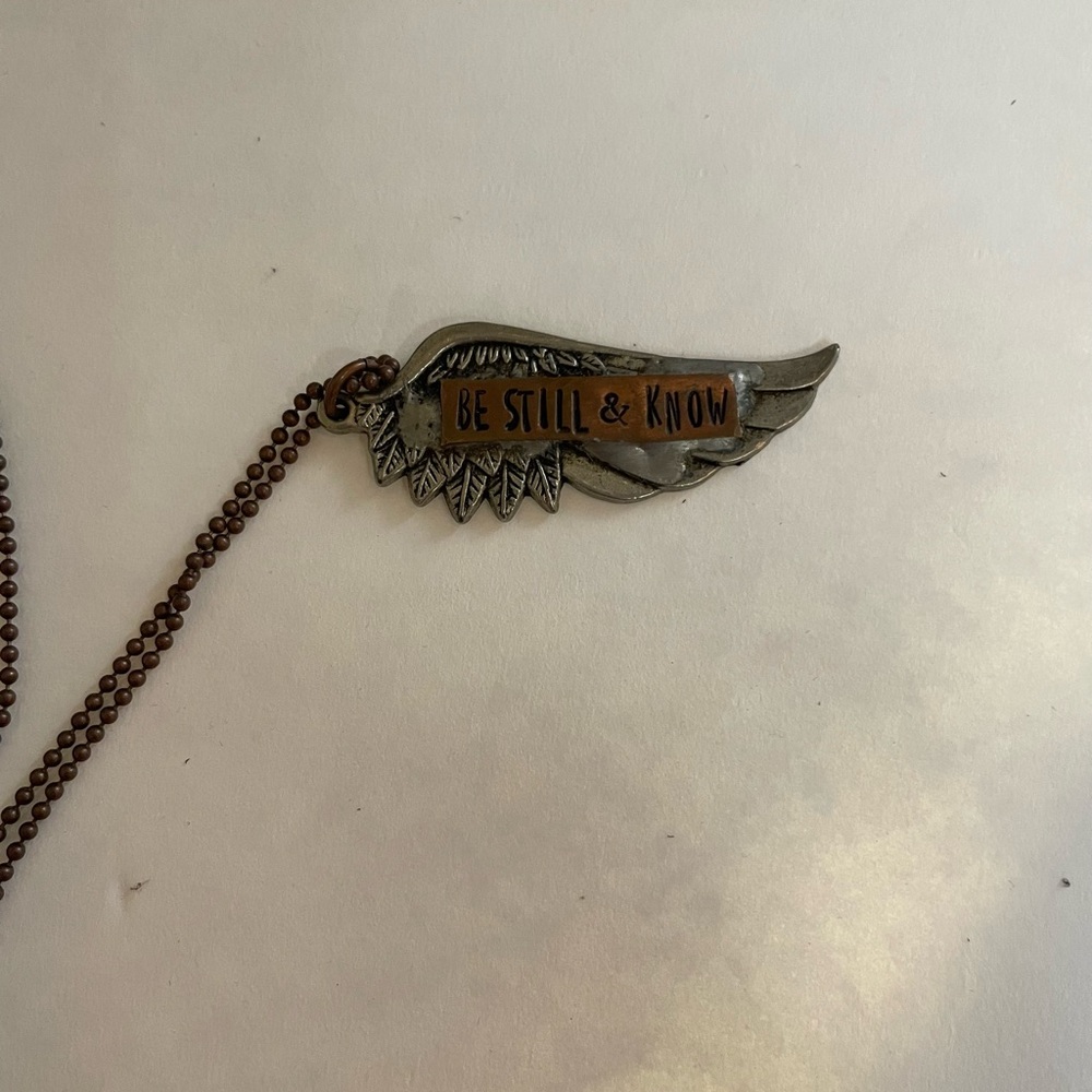 Be still and know wing necklace